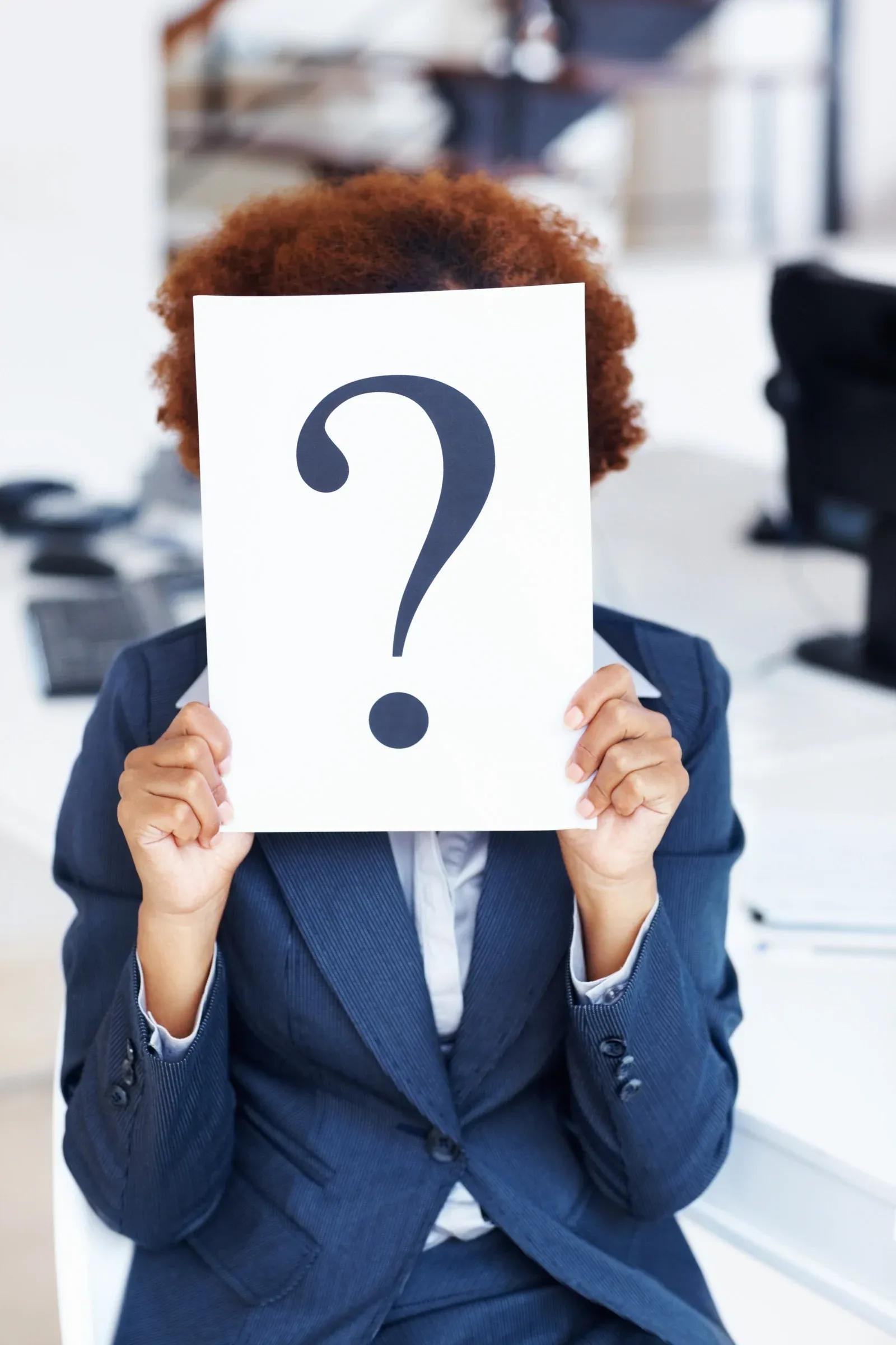 Person holding question mark sign